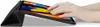 A person's hands are interacting with a tablet device that is propped up by its case. Podgląd zdjęcia produktu