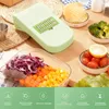A kitchen counter with a vegetable slicer and prepared vegetables. Náhľad obrázku produktu