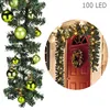 A Christmas garland with ornaments and lights, and a decorated door. Voir les images du produit