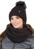 A woman wearing a black knitted hat with a pom-pom and a matching infinity scarf. Náhled obrázku produktu