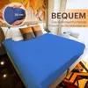 A bed with a blue fitted sheet, pillows, and a headboard with abstract art. Produktbild-Vorschau