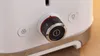 A close-up view of the control dial and buttons on a white toaster. Produktbild-Vorschau