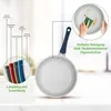 A frying pan is shown with a diagram illustrating its layers and a close-up of someone cleaning it. Produktbild-Vorschau