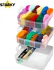 A multi-tiered storage container filled with colorful wool roving and some crafting tools. Produktbild-Vorschau