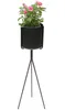 A black metal plant stand with a potted pink rose plant on a white background. Anteprima dell’immagine prodotto