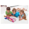 Three children are lying on a white rug, looking at a pink laptop. Produktbild-Vorschau