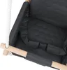 A close-up view of a dark gray baby swing with a wooden frame and a white rope. Produktbild-Vorschau