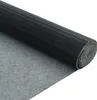 A rolled-up black mat with a ribbed texture on one side and a gray felt-like material on the other, shown diagonally against a white background. Voir les images du produit