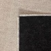A close-up view of the corner of a rug, showing the texture of the pile and the backing. Náhled obrázku produktu