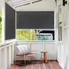 A balcony with a chair and a side table, featuring a dark grey roller blind as a privacy screen. Náhled obrázku produktu