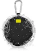 A black, round Bluetooth speaker with a silver carabiner clip, partially covered in water splashes. Produktbild-Vorschau