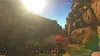 A first-person perspective of a desert canyon environment with a hand holding a water bottle. Produktbild-Vorschau