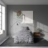 A bedroom scene with a bed, a painting, and a lamp. Produktbild-Vorschau