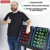 A man is giving a thumbs up next to two blue crates filled with bottles, one with red caps and one with green caps. Produktbild-Vorschau
