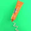A tube of Curaprox toothpaste is shown on a bright green background, with a swirl of toothpaste on the surface. Anteprima dell’immagine prodotto