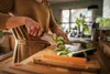 A person is chopping vegetables in a kitchen. Podgląd zdjęcia produktu