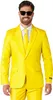 A man wearing a yellow suit and sunglasses, posing for a product photo. Náhled obrázku produktu