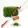 A red and black electric hedge trimmer with a telescopic pole is shown diagonally against a white background, with a green hedge and a pile of cut leaves in the foreground. A yellow and red sign hangs from the trimmer. Produktbild-Vorschau