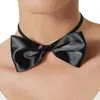 Close-up of a black bow tie worn around a person's neck. Produktbild-Vorschau
