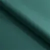 A close-up, angled view of a folded piece of teal fabric. Voir les images du produit