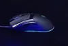 A gaming mouse with blue LED lighting on a black background. Produktbild-Vorschau