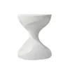 A white, speckled, hourglass-shaped side table is shown against a white background. Anteprima dell’immagine prodotto