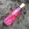 A bottle of Victoria's Secret Romantic fragrance mist is placed on a grey, furry surface. Produktbild-Vorschau