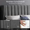 A close-up view of a dark gray upholstered bed frame with a textured fabric, featuring text overlays highlighting product features. Podgląd zdjęcia produktu