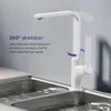 A white kitchen faucet is shown over a double sink with water running. Podgląd zdjęcia produktu