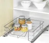 A pull-out cabinet organizer with jars of pasta inside, placed in a cabinet with white shelving. Náhľad obrázku produktu
