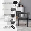 A dark gray armchair with black metal legs is shown in a room with a fireplace and logs. Callouts highlight product features. Produktbild-Vorschau