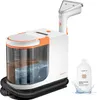 A white and orange upholstery cleaner with a transparent tank showing water and cleaning solution, next to a bottle of cleaning solution. Náhled obrázku produktu
