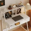 A white computer desk with various decorative items and a laptop. Produktbild-Vorschau