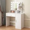 A white vanity table with a lighted mirror, drawers, and a cabinet, set against a neutral wall and curtains. Náhled obrázku produktu