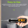 A hand holding a small electric screwdriver, with the screwdriver tip inserted into a piece of wood. Náhled obrázku produktu