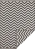 A black and white chevron patterned rug shown from a diagonal angle, with one corner folded back. Voir les images du produit