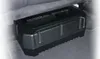 A black car subwoofer is placed under a car seat. Produktbild-Vorschau