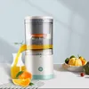 A product shot of an electric juicer with oranges and other fruits in the background. Produktbild-Vorschau