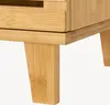A close-up view of the legs and bottom edge of a wooden cabinet. Podgląd zdjęcia produktu