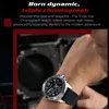 A man's wrist wearing a watch, with a blurred background of machinery. Náhled obrázku produktu