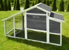 A chicken coop with an attached run sits on a grassy lawn with trees in the background. Produktbild-Vorschau