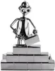 A metallic figurine of a construction worker building a wall. Náhled obrázku produktu