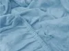 A close-up view of a light blue terry cloth bed sheet, showing the texture of the fabric and the elasticized edge. Náhľad obrázku produktu