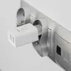 A white dual USB charger plugged into a silver power strip. Produktbild-Vorschau