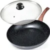 A black frying pan with a speckled surface and a wooden handle, shown with a clear glass lid slightly ajar. Produktbild-Vorschau