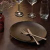 A table setting with a plate, cutlery, wine glasses, and a vase with flowers. Náhľad obrázku produktu