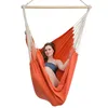 A woman sits in an orange hammock chair. Podgląd zdjęcia produktu