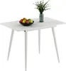 A white dining table with a bowl of fruit and a vase of greenery on it, set against a white background. Náhľad obrázku produktu