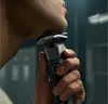 A close-up shot of a person shaving their face with an electric razor. Náhled obrázku produktu