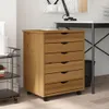 A wooden filing cabinet with multiple drawers is positioned next to a desk. Voir les images du produit